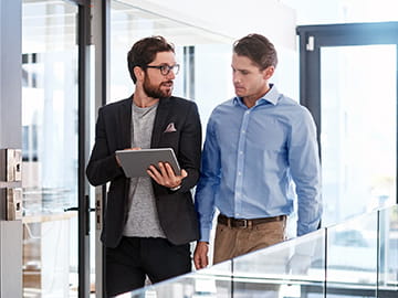 two businessmen walking and talking