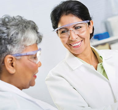 lab tech using a microscope