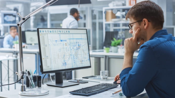 Engineer analyzing a design on a computer program