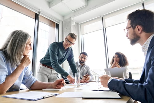 Corporate workers strategizing around a table