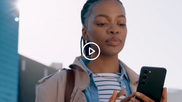 woman looking at mobile phone with sunlight behind her