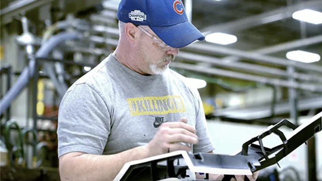 Male industrial worker inspecting parts